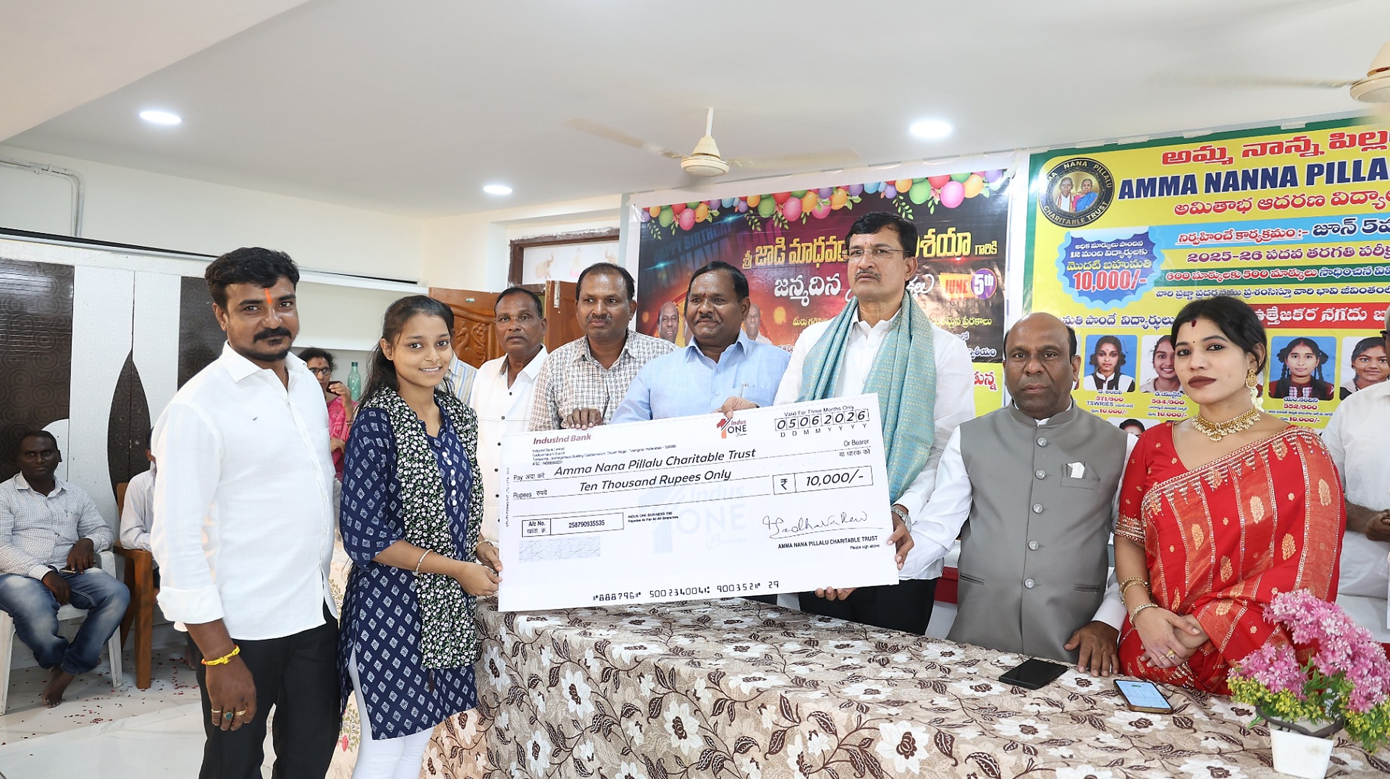Another meritorious student being awarded a ₹10,000 scholarship cheque